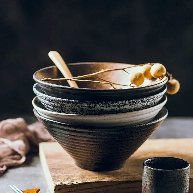 Hue and  Dunes Singapore Japanese ceramic bowl set featuring four stylish bowls in various designs stacked on a wooden board